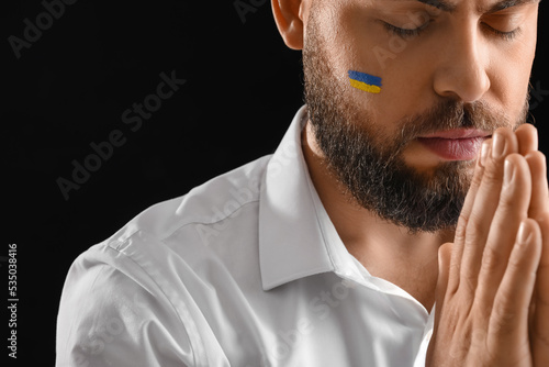Young man with drawn flag o...