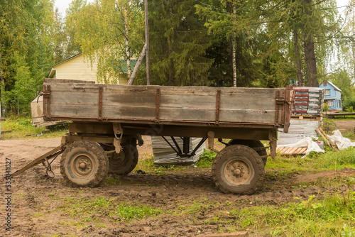 a large trailer with a wooden body for agricultural work on the farm. © Dmitry