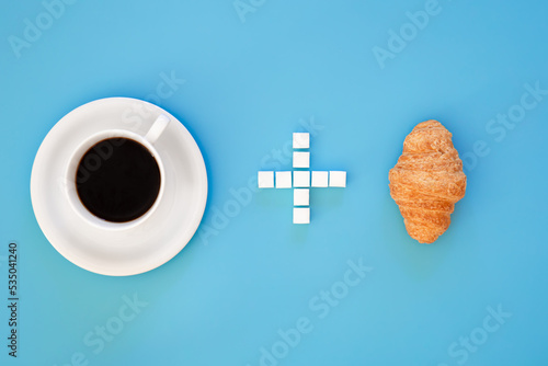 Принти на полотні A cup of coffee, a plus sign made of sugar, and a croissant, flat lay