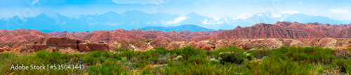 Natural unusual landscape of red rocks against the backdrop of blue mountains. The extraordinary beauty of nature is similar to the Martian landscape. Amazingly beautiful landscape.