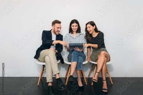 During a break, a group of businesspeople chat and express satisfaction with their job.