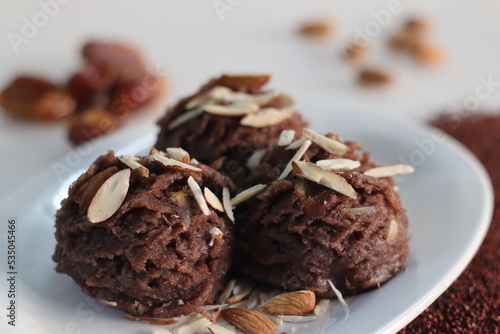 Ragi dates Sheera. Indian pudding made of finger millet flour ghee, milk, dates and dry fruits. Traditionally known as ragi halwa. photo