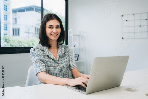 Businesswoman looking camera and a meeting about papers and concepts in office