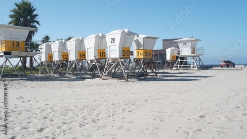 Lifeguard stand and palm tree, life guard tower for surfing on California beach. Summer pacific ocean in USA aesthetic. Iconic rescue baywatch station, coast lifesavers wachtower hut or house by sea.