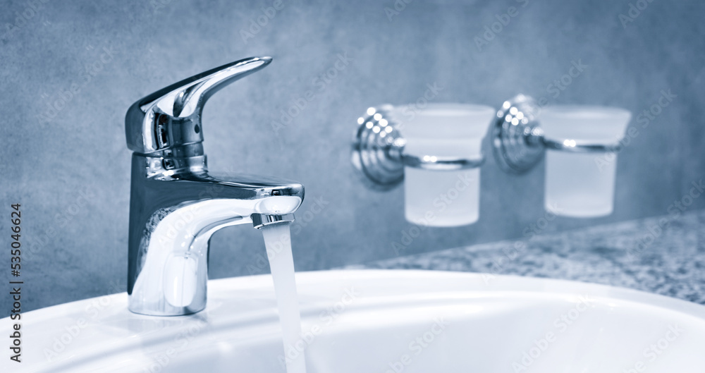 Bathroom water mixer. Water tap made of chrome material, Faucet with water in blue tone