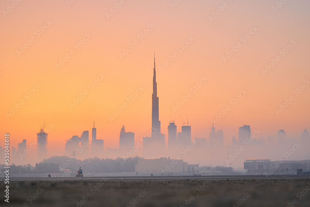 Dubai skyline covered with mist during sunset