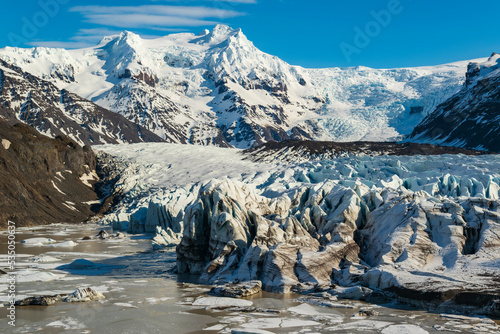 Scenic view of the mighty Svínafellsjökull glacier on a sunny day in spring, Skaftafell, Vatnajökull National Park, Iceland photo