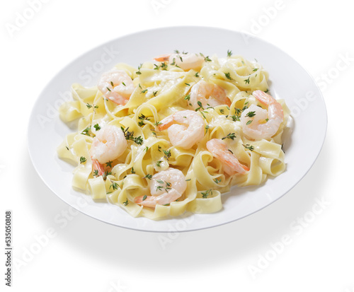 plate of pasta fettuccine with cream sauce and shrimps on white background