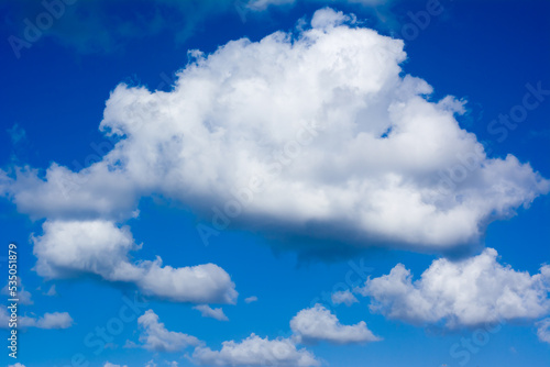 Fluffy clouds on vibrant blue sky