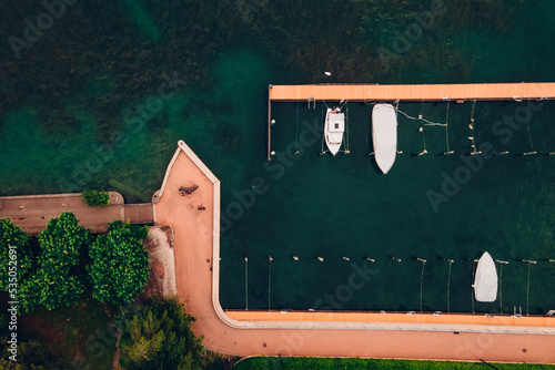 Melide docks in south switzerland ticino with green lake and no people due to covid19 with few boats