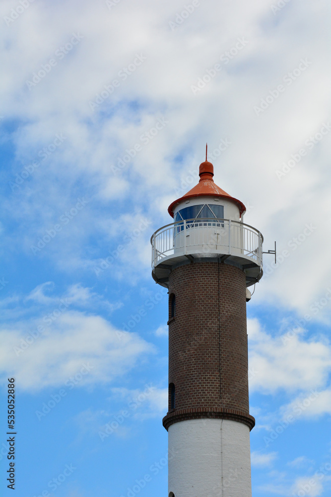 Lighthouse on the island of Poel on the Baltic Sea with clouds and sky