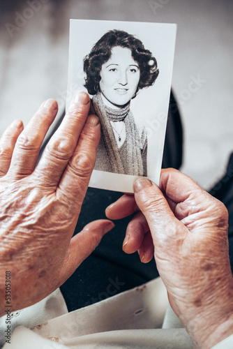 CIRCA 1970: Elderly woman hands holding vintage, black and white photo