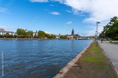 Frankfurt city center seen from across the river, with the cathedral tower, on a partly sunny day. © Montse