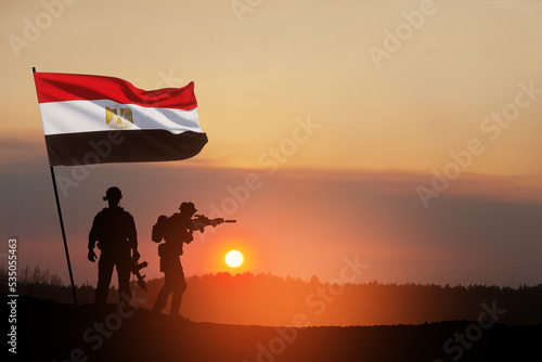 Silhouette Of Soliders Against the Sunrise in desert . Concept - armed forces of Egypt. Egypt celebration. Greeting card for Independence day, Memorial Day, Armed forces day, Sinai Liberation Day.