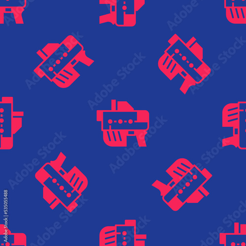 Red Futuristic space gun blaster icon isolated seamless pattern on blue background. Laser Handgun. Alien Weapon. Vector