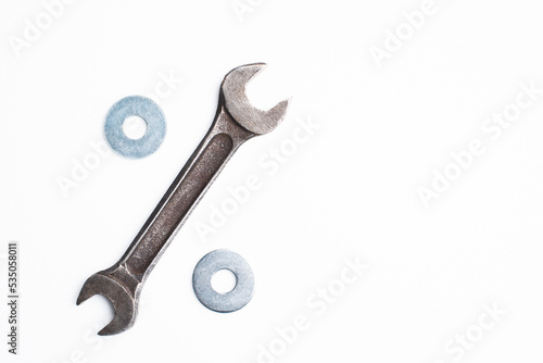 the adjustable wrench and steel rings are depicted as a percent sign on a white background