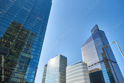 Administrative center in Warsaw  Business office buildings in downtown central district  Skyscrapers with glass facade against blue sky