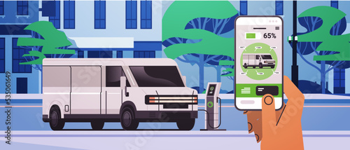 hand charging electric cargo van in mobile app battery vehicle at recharging power station charger EV management