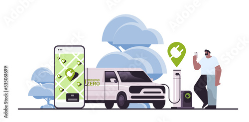 man charging electric cargo van in mobile app battery vehicle at recharging power station charger EV management zero emission