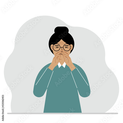 The woman covers his nose with his hands. The concept of a sick person, sneezes, seasonal allergies, bad smell.