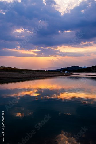 sunset with reflection over a dam