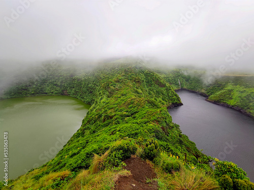Twin volcano crater lakes at foggy day, Lagoa Negra (black lagoon) and Lagoa Comprida (long lagoon) on the island of flores at azores in portugal

