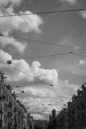 Overhead contact lines with the street and clouds