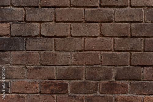 Old brick wall with ruined bricks. Aged grunge wall background. Vintage Texture. Vertical Web banner or Wallpaper With Copy Space for design.