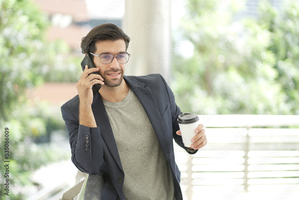 successful businessman on the background of a bright office. businessman standing with looking at camera happy. caucasian. successful businessman on the background of a bright office. businessman standing with looking at camera happy. caucasian.