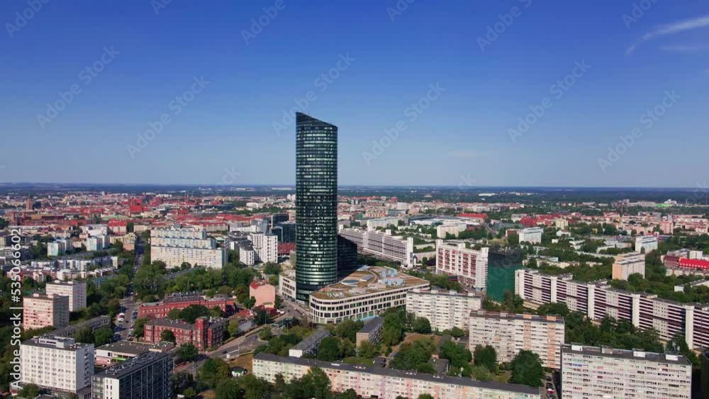 Drone flight over Wroclaw cityscape with Sky Tower skyscraper. Aerial view of modern european city in Poland Drone flight over Wroclaw cityscape with Sky Tower skyscraper. Aerial view of modern european city in Poland