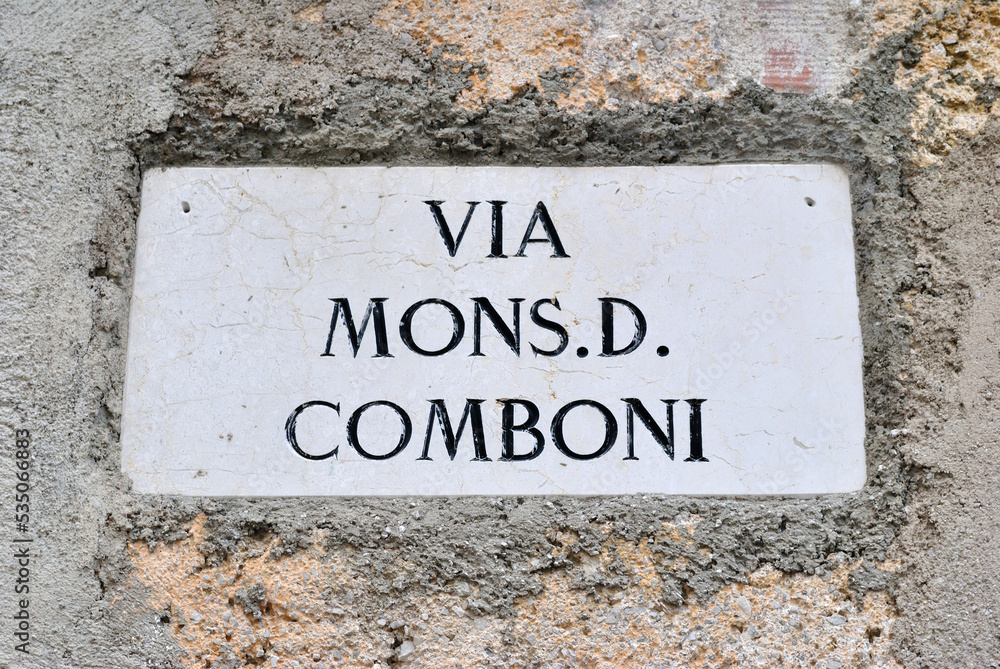 Close Up of Old Italian Stone Street Name Translated as 'Mister D Comboni Street' Close Up of Old Italian Stone Street Name Translated as 'Mister D Comboni Street'