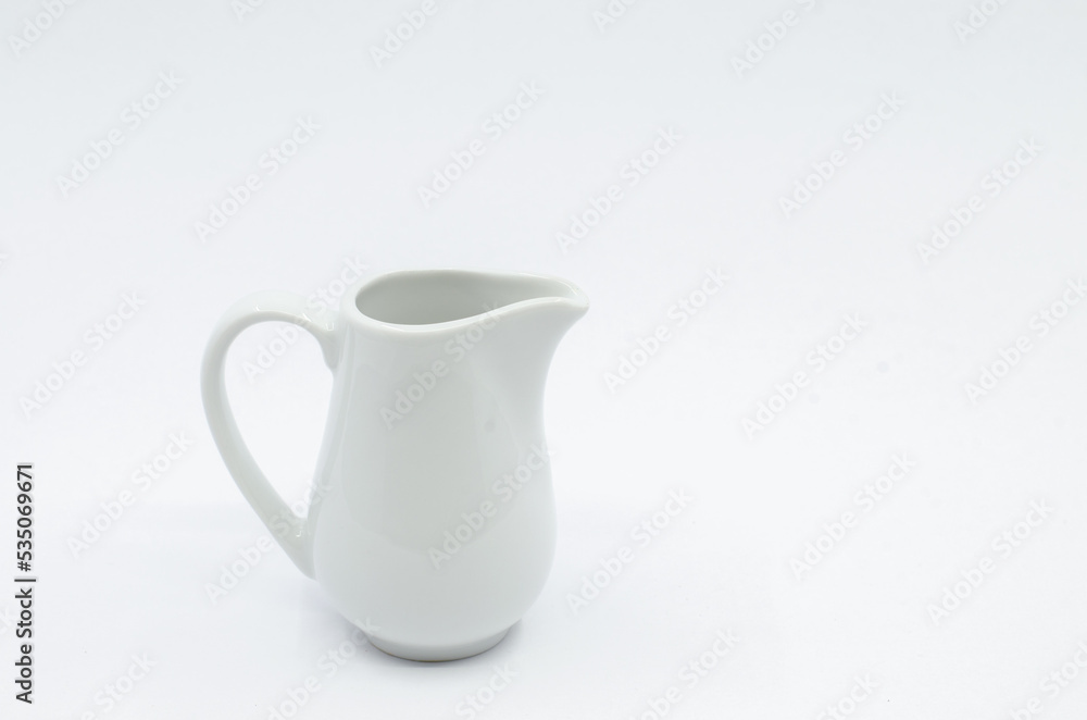 Small milk pot. Porcelain milk pot isolated on a white background.
Small milk pot. Porcelain milk pot isolated on a white background.