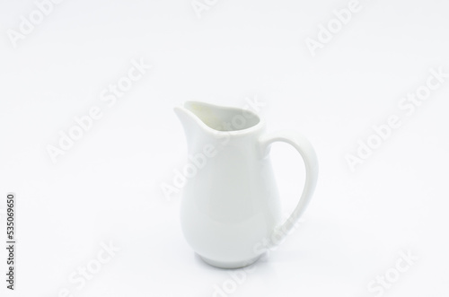 Small milk pot. Porcelain milk pot isolated on a white background.
