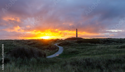 Sunset on island with lighthouse. Ameland Hollum photo