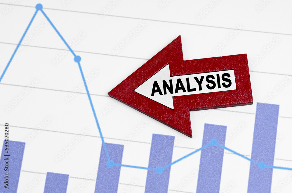 Fototapeta premium On the reporting chart there is an arrow with the inscription - ANALYSIS