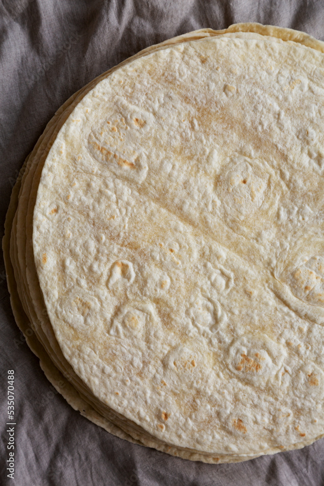 Homemade Wheat Flour Tortillas in a Stack, top view. Flat lay, overhead, from above. Homemade Wheat Flour Tortillas in a Stack, top view. Flat lay, overhead, from above.