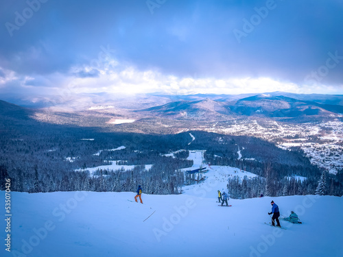 Winter landscape in Sheregesh ski resort in Russia, located in Mountain Shoriya, Siberia. Ski slopes and a view of the Sheregesh village