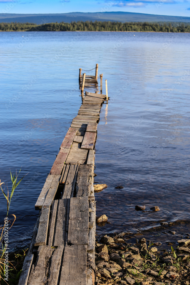 Old wooden footbridges on the shore of the lake
