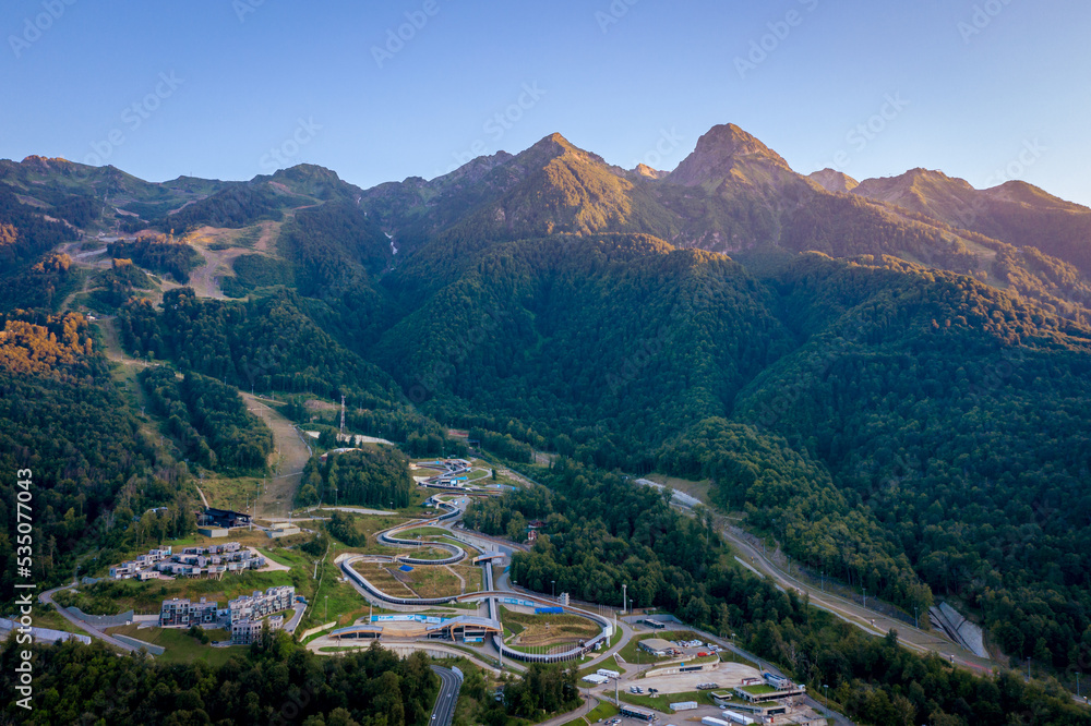 Rosa Khutor aerial panoramic view. Evening landscape in the mountains of the Caucasus. Sochi, Russia