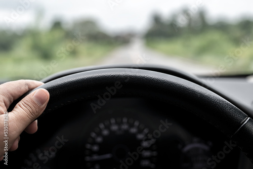 Close-up of steering wheel while driving car