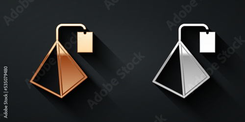 Gold and silver Tea bag icon isolated on black background. Long shadow style. Vector