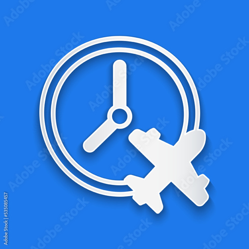 Paper cut Clock with airplane icon isolated on blue background. Designation of time before departure, check-in for flight and arrival time symbol. Paper art style. Vector