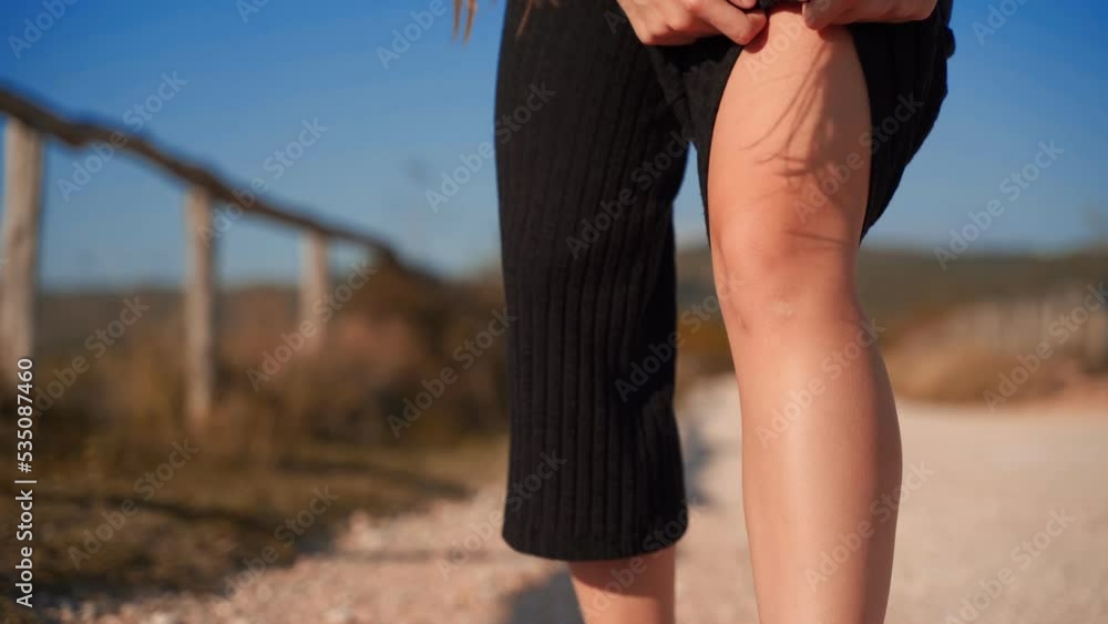 Girl massaging his knees after running in the hills. She had knee pain