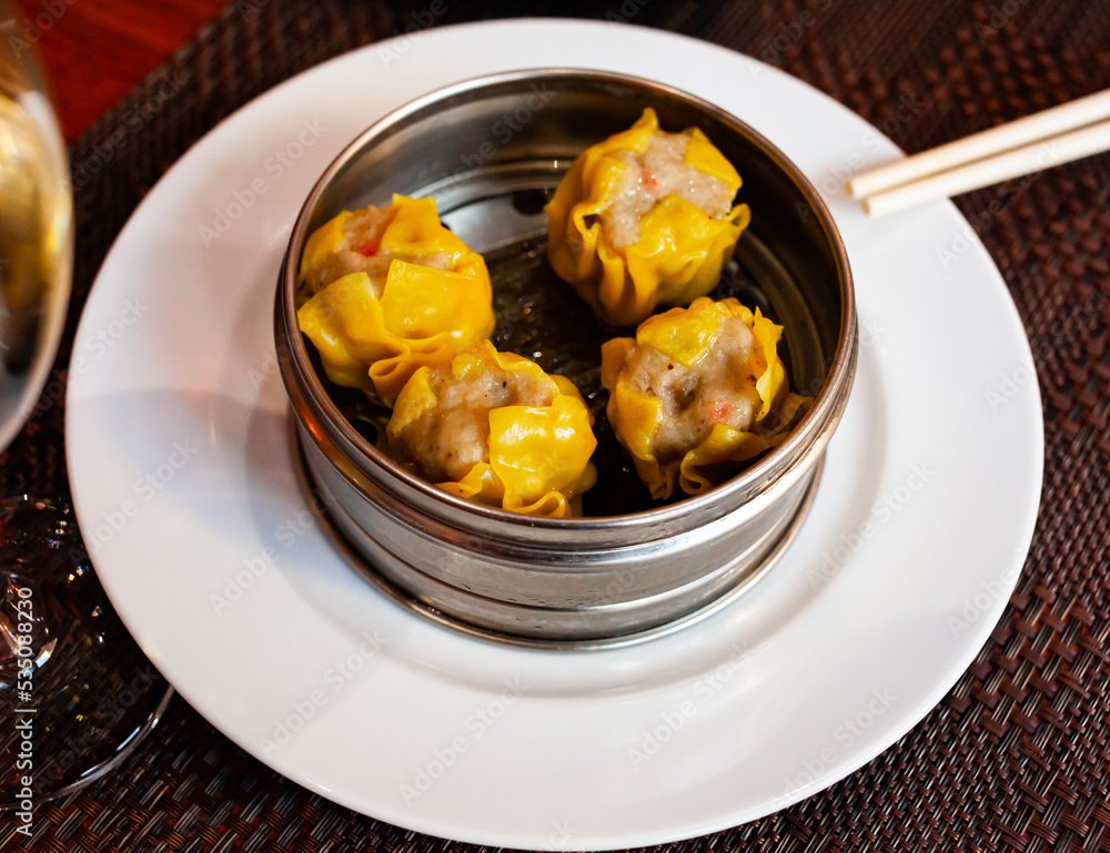 Japanese style Shumai dumplings stuffed with minced pork and vegetables served with soy sauce