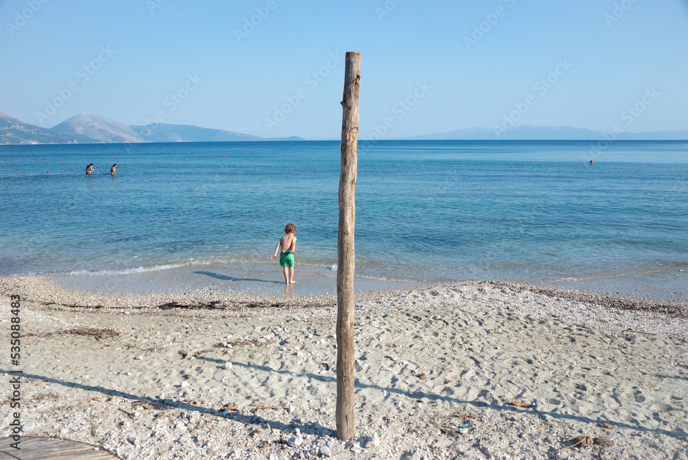 A child playing on the shore at the beach