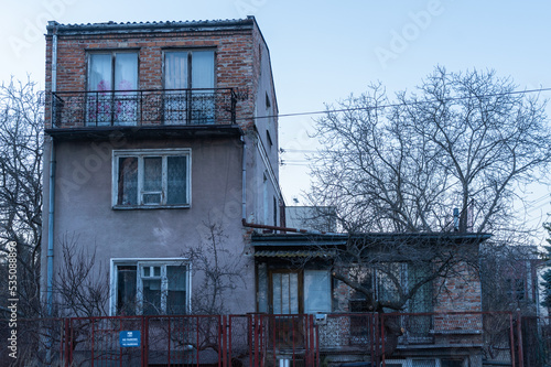 old house with brick superstructure house in bad condition photo taken in early spring in cloudy weather