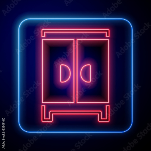 Glowing neon Wardrobe icon isolated on black background. Cupboard sign. Vector