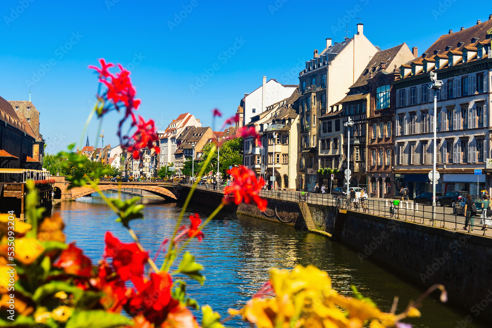 Sunny summer day in Strasbourg, Grand Est region of eastern France. View of houses along canal.