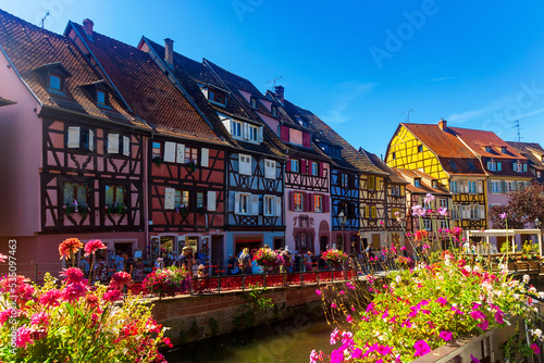 Picturesque summer view of Little Venice quarter in Colmar with small half-timbered houses located on banks of canal flowing through city center, France