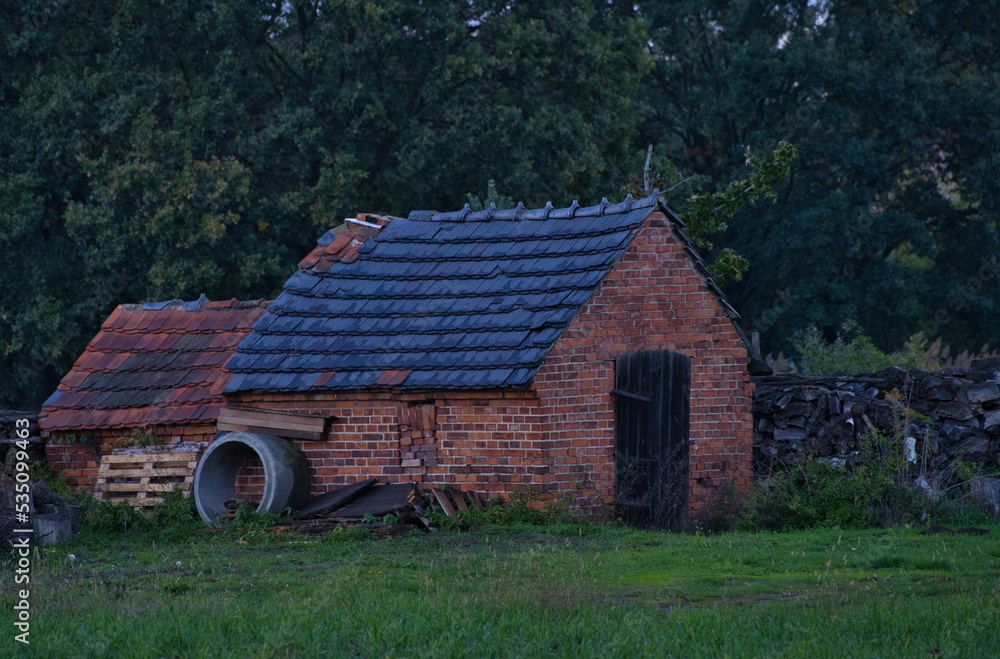 Fototapeta premium old dilapidated brick shed in the countryside